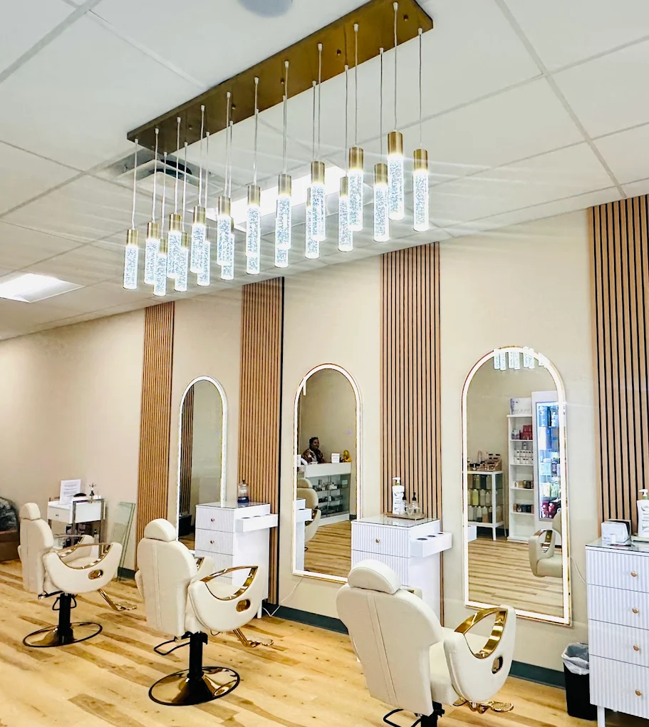 Gold-trimmed cream chairs in the salon
